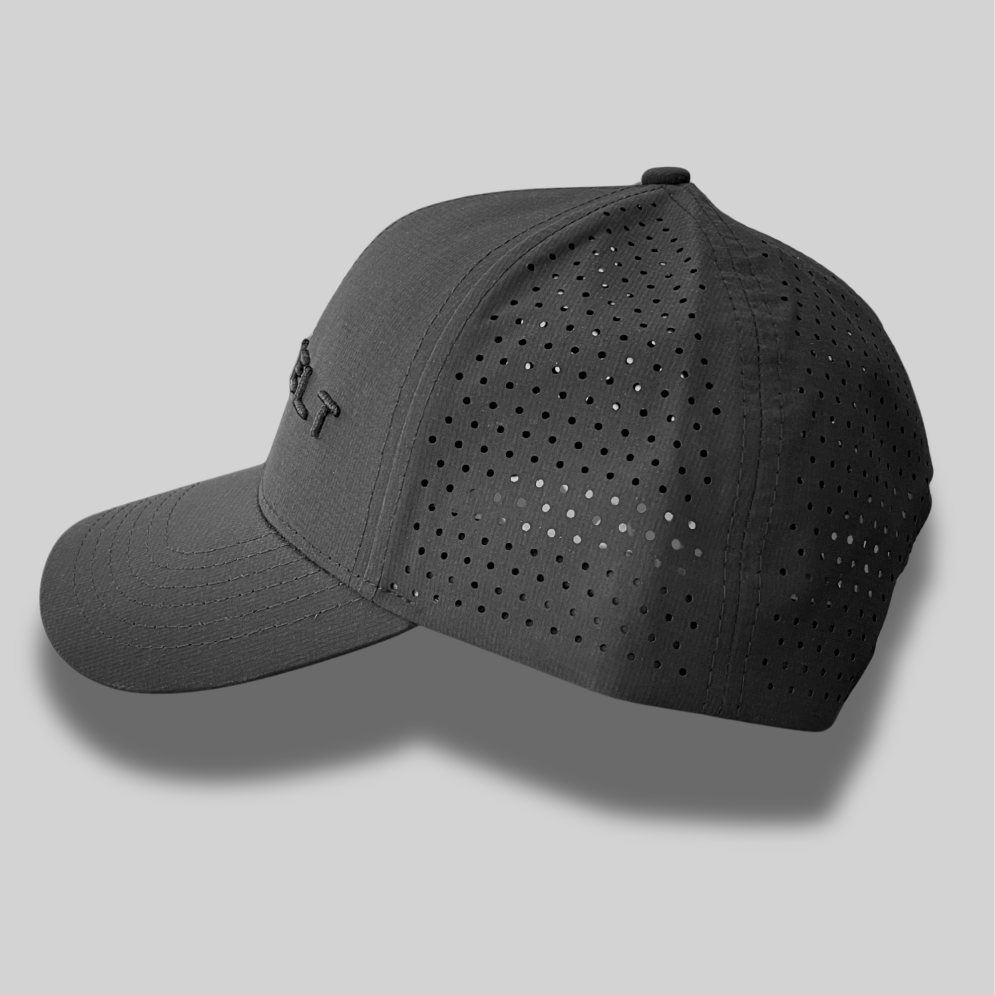 Black Rozvelt cap with perforated design on a gray background